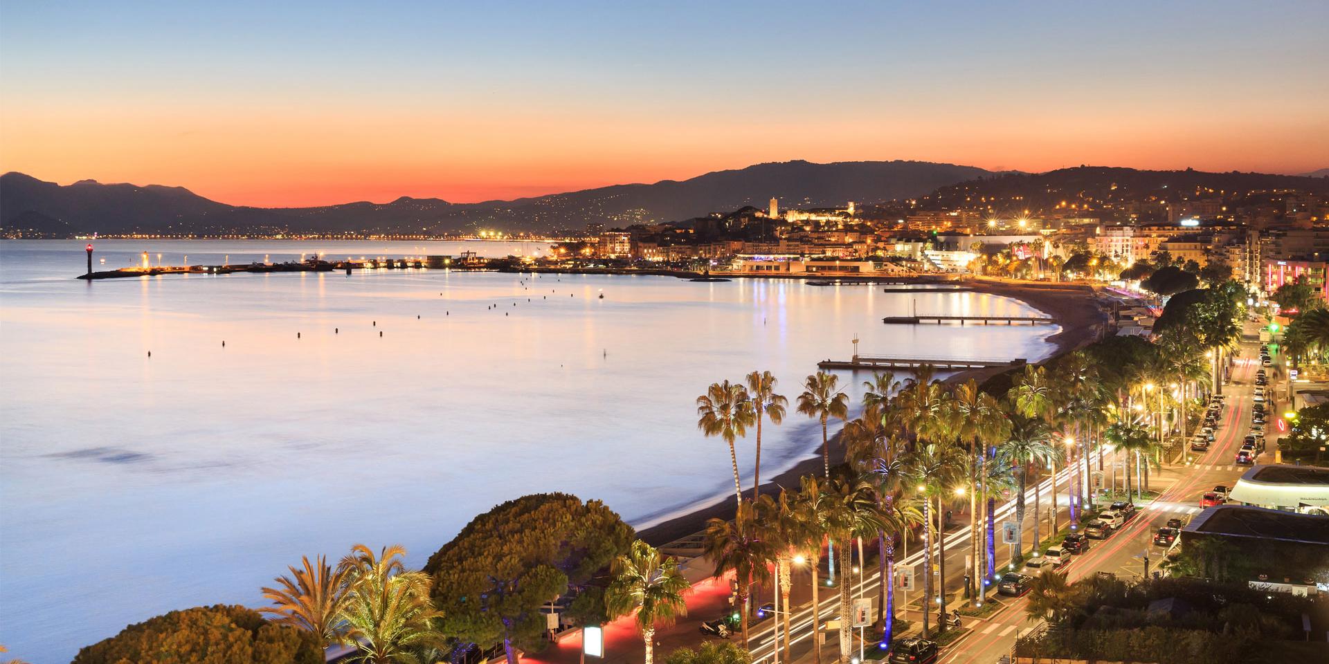 Cannes bay and the illuminated Croisette at sunset